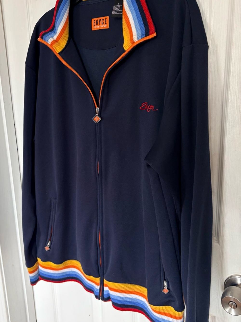 Enyce Navy Jacket with Orange Logo Patch and Multicolor Stripe Trim